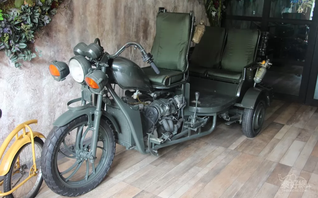 入口處擺有3輛車：三輪車、摩托車、汽車。