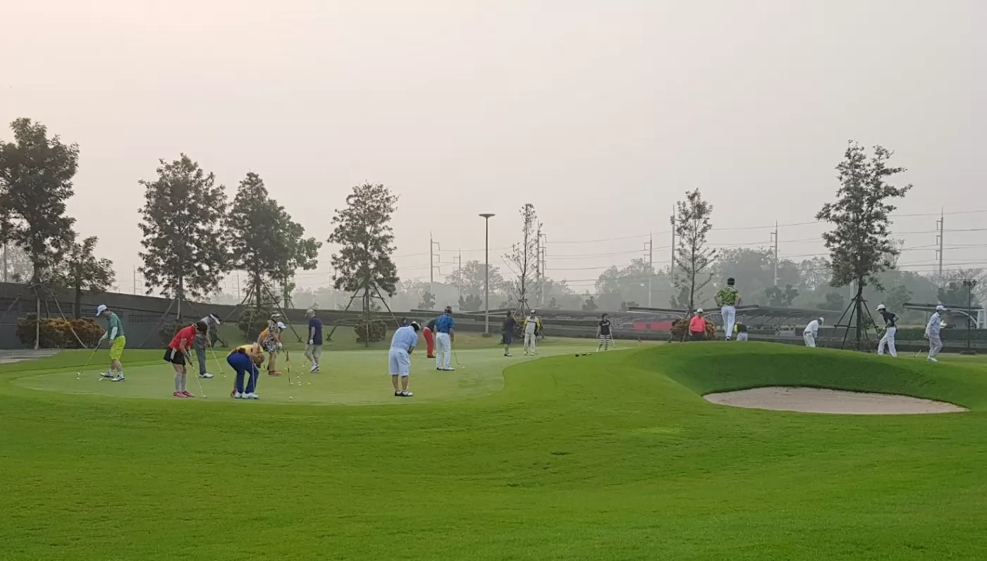 眾多球友在果嶺上練習推桿。